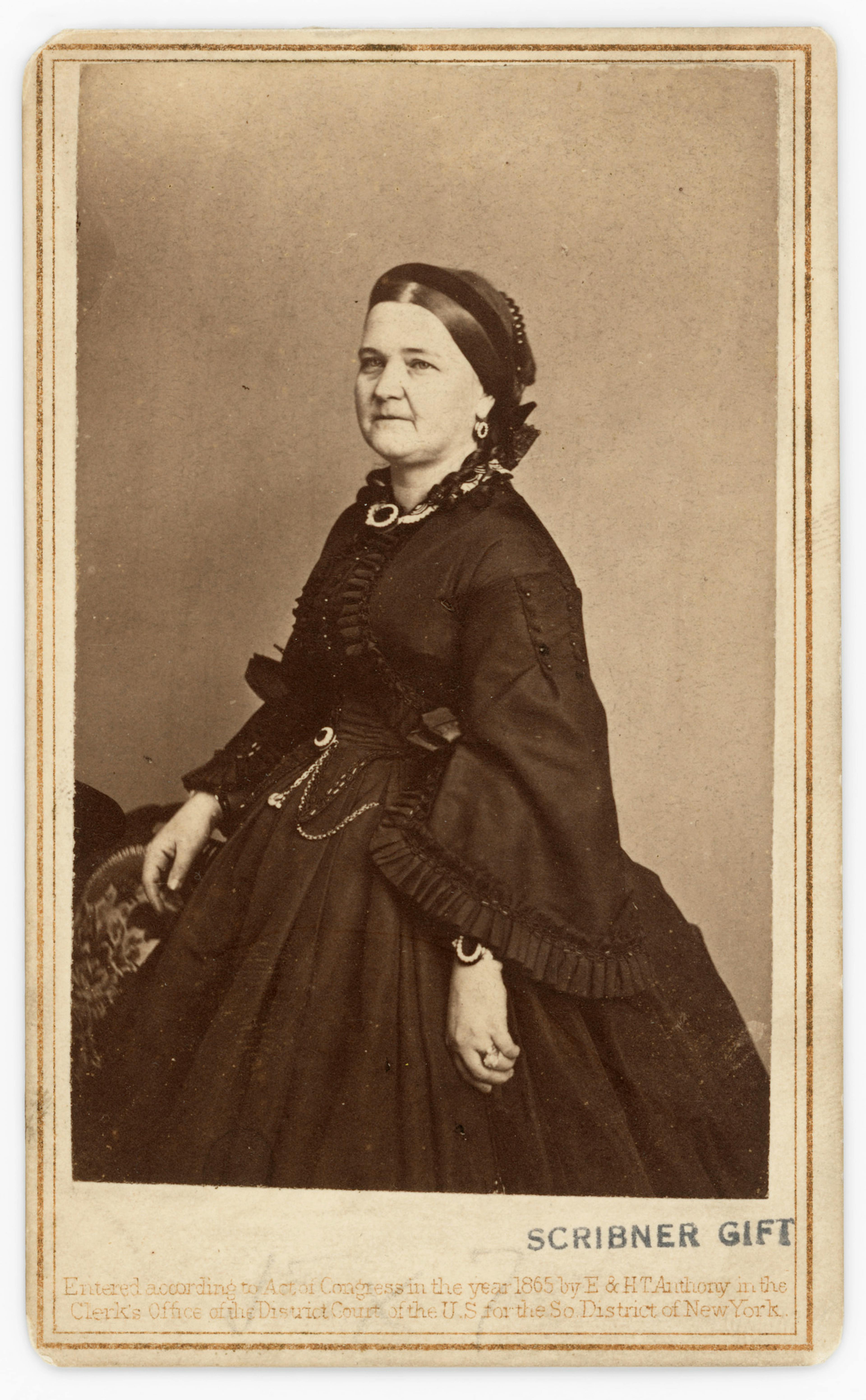 Black and white portrait photo of Mary Todd Lincoln in a floor-length gown.